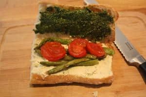 Vegan pesto, cashew cheese, roasted asparagus and tomato sandwich