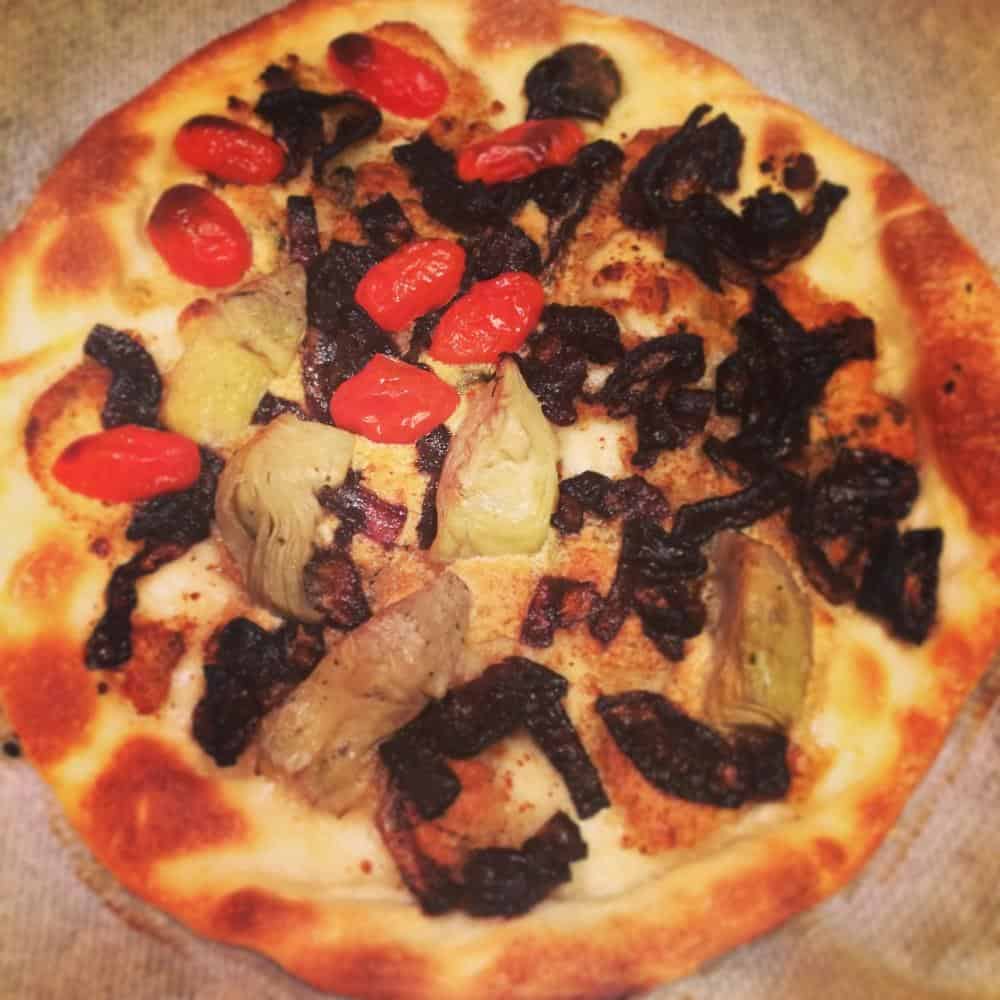 Vegan gorgonzola, caramelised onion, tomato and artichoke heart pizza