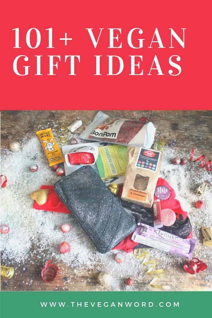 A wallet, snacks, chapstick and more are covered in snow and gift wrap ribbons. Pin with the top saying "101+ vegan gift ideas" and website URL at the bottom