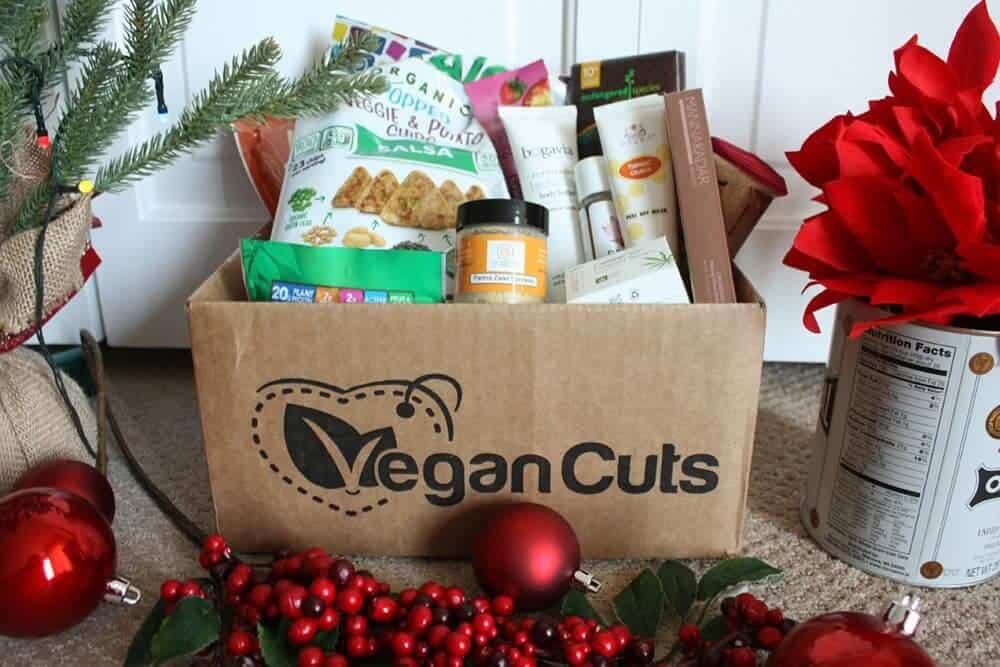 Vegancuts box full of snacks and beauty products. Vegan gifts: vegan box