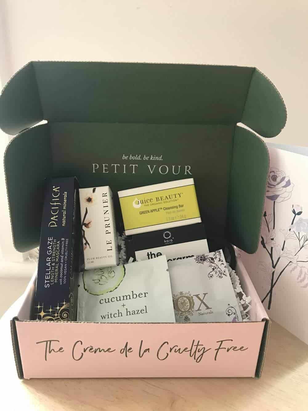 Pink cardboard box (which says "the creme de la cruelty free" on the side) containing a cleansing bar, natural mascara and other beauty products