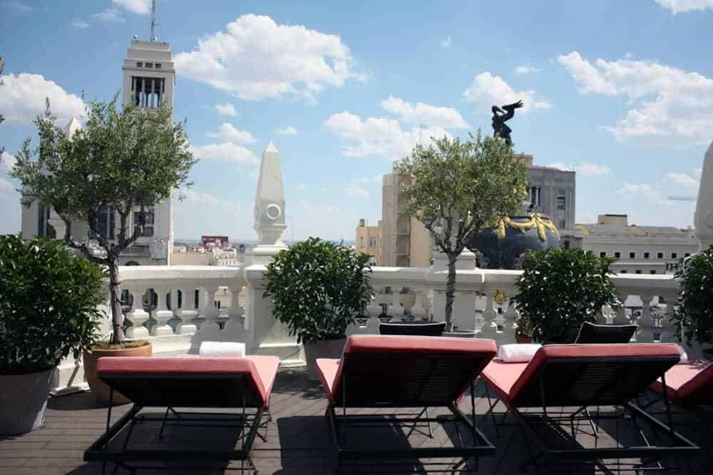 Terrace in Madrid showing sun loungers overlooking city view