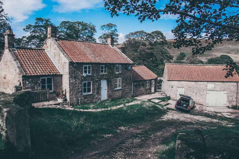 Stone cottage set in front of hill