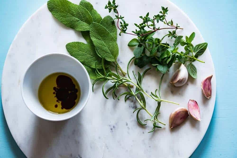 Herbs, garlic and oil on a platter