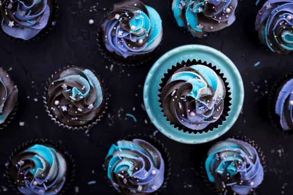 Cupcakes with blue and purple frosting.