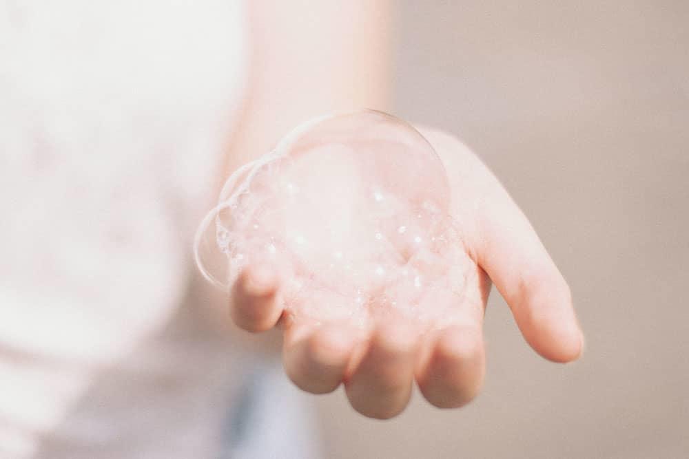 Hand holding soap bubbles