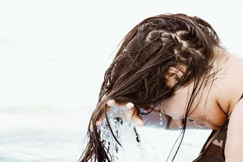 Woman with wet hair in front of face