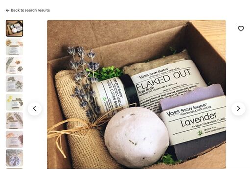 A box containing soap, a bath bomb and a spring of lavender