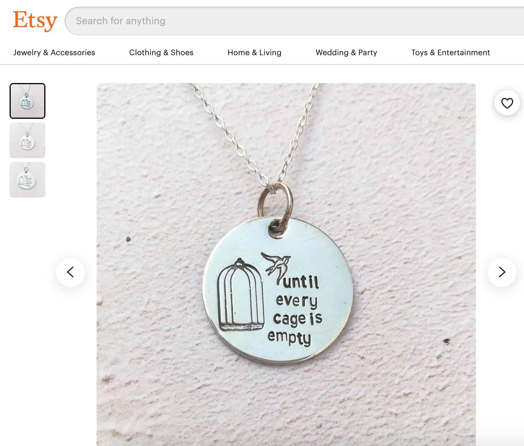 Necklace with a bird flying away from cage. Text on necklace says "until every cage is empty"