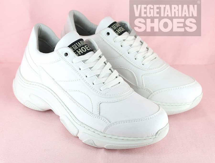 White vegan leather trainer with white sole and laces and Vegetarian Shoes logo on tongue