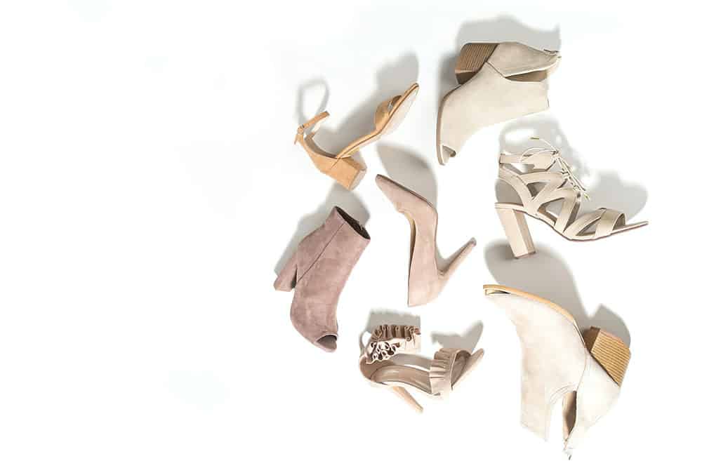 Selection of shoes in colours from white to cream to beige and grey: sandals, heels, boots