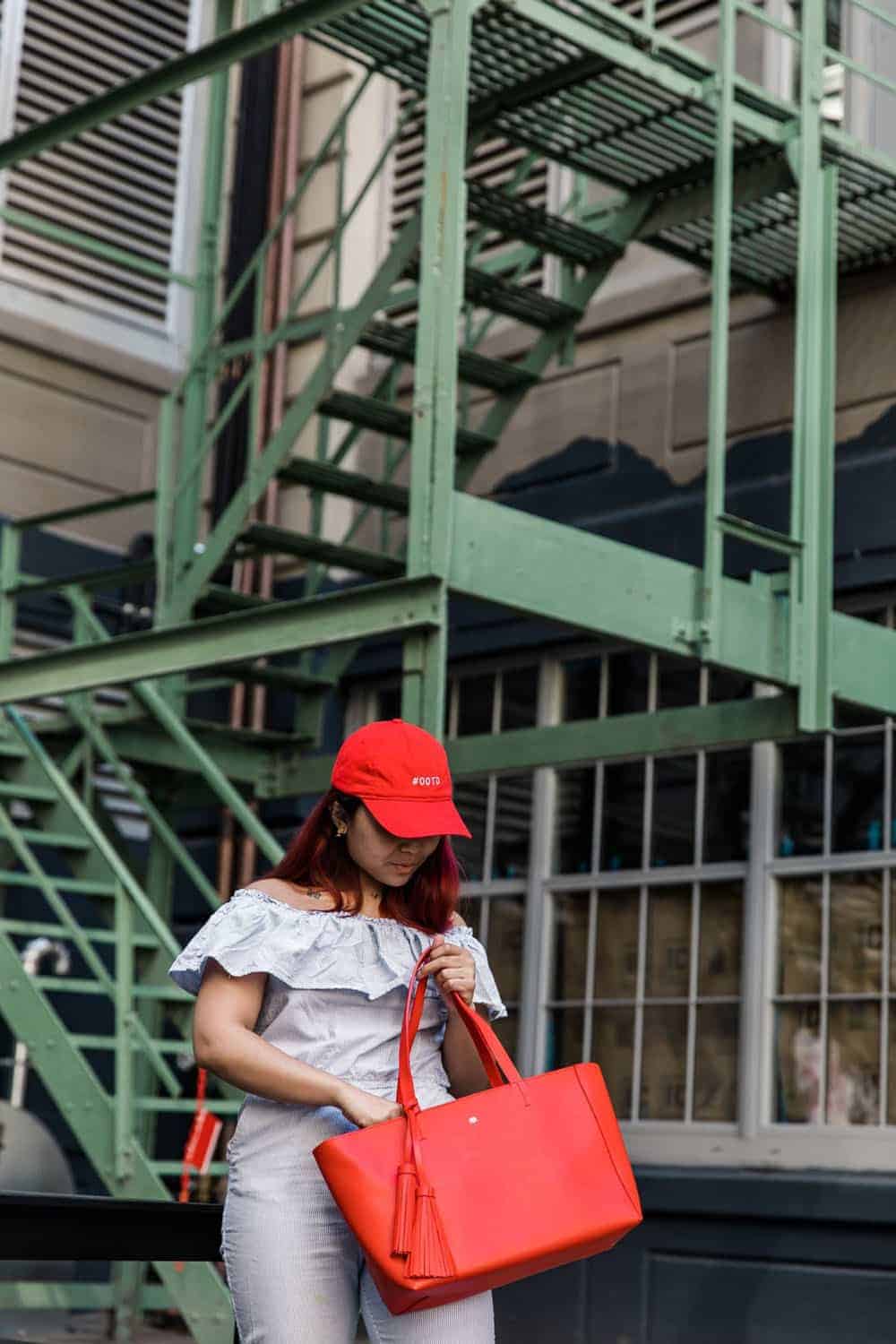 Person looking inside their red tote bag