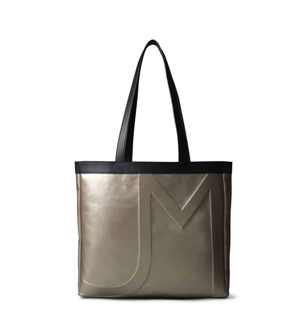 Gold tote bag vegan with black handles and trim, with large JM embossed on the front