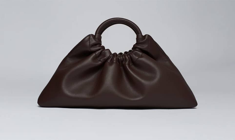 Ruched triangular shaped vegan bag with circular top handle from Nanushka