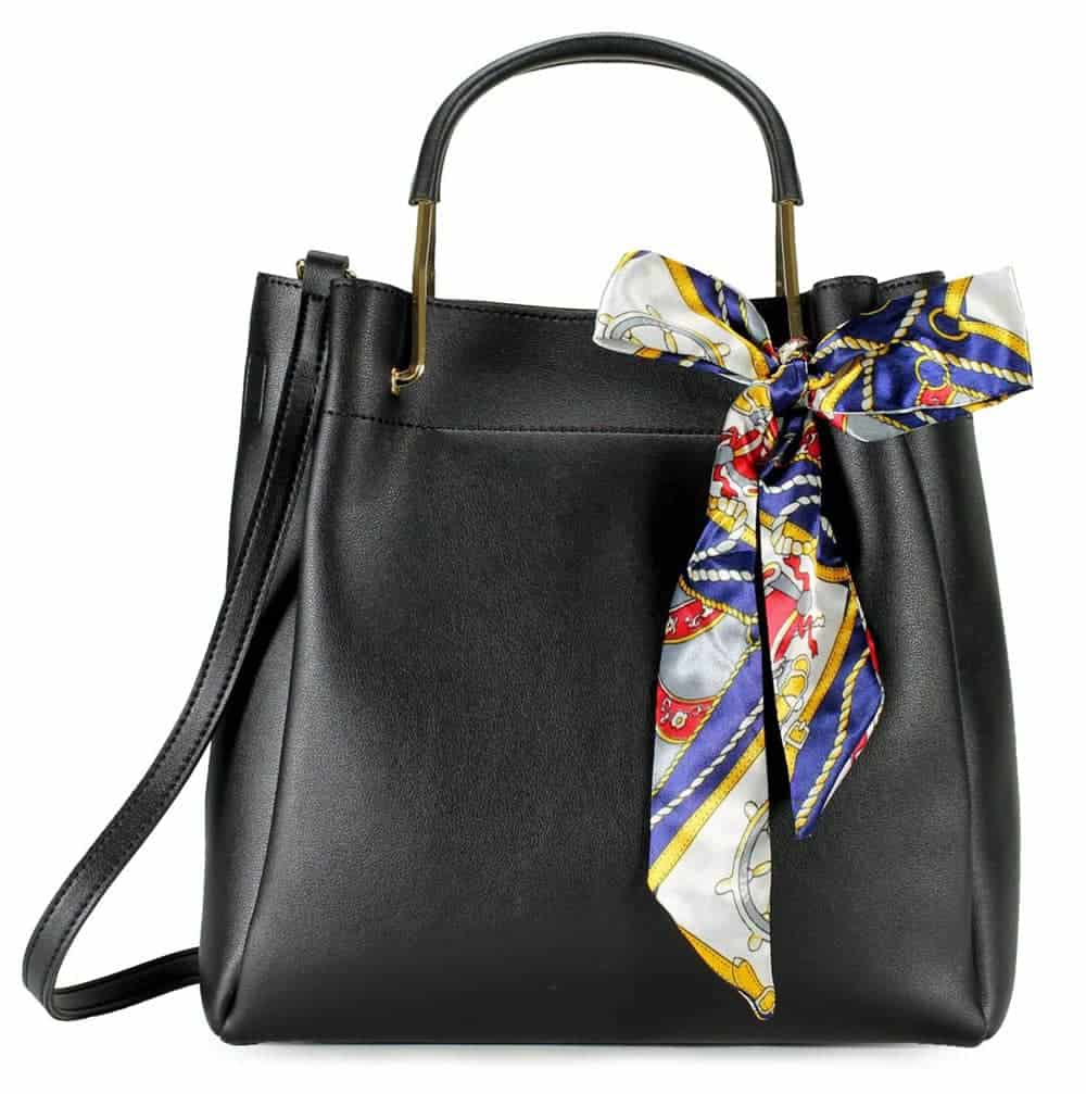 Black vegan leather bag with decorative colourful bow tied to handle
