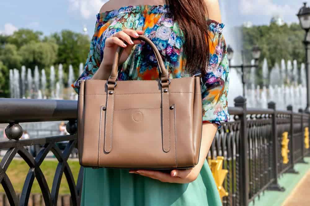 Person holding brown tote bag