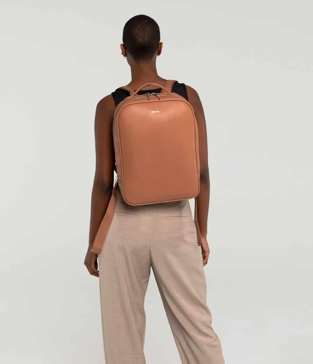 Person shown from behind wearing peach backpack vegan leather from Matt and Nat