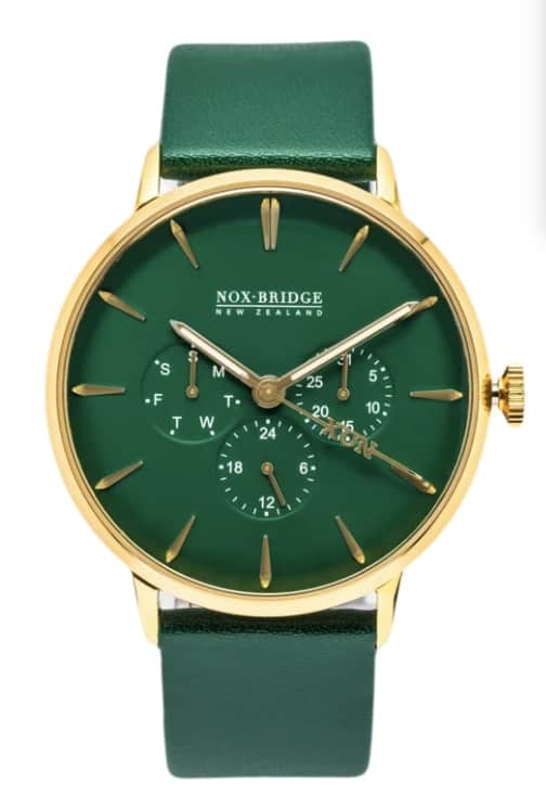 Watch with forest green strap, forest green dial, gold hardware and miniature dials within the watch face showing day of the week and date