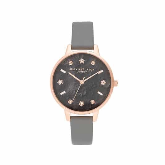 Watch with grey strap, black dial, rose gold hardware. Instead of numbers, watch dial has rhiestones and stars as well as lines, all in rose gold