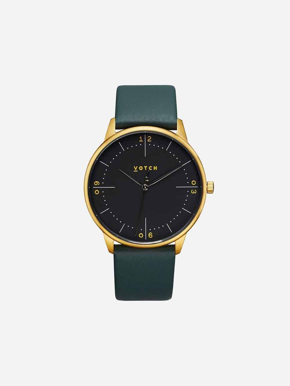 Watch with black dial, gold hardware and dark green strap from vegan watch UK brand Votch
