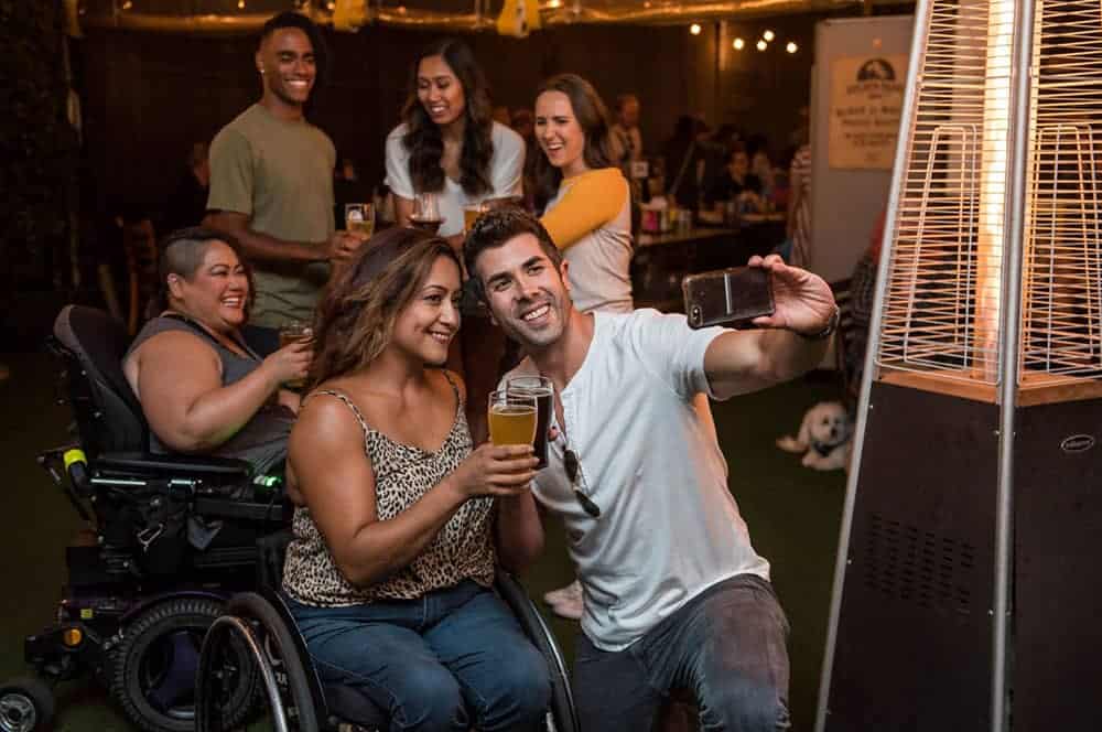 Group of people in bar taking selfies