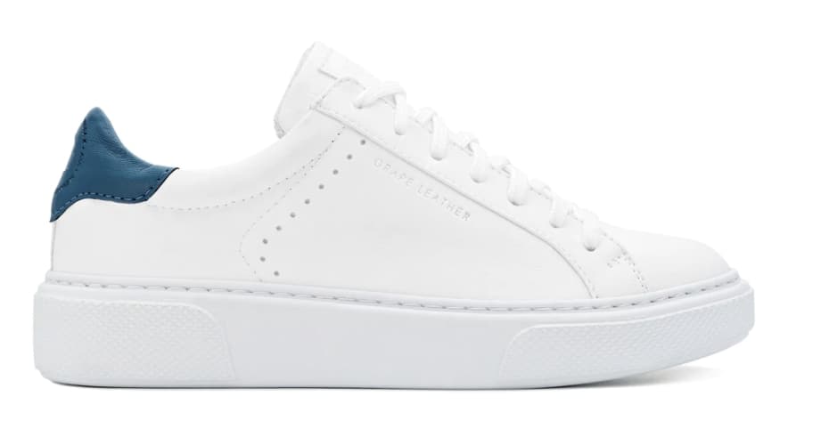 Vegan white grape leather sneaker with white sole and white laces and dark blue vegan corn leather trim on heel