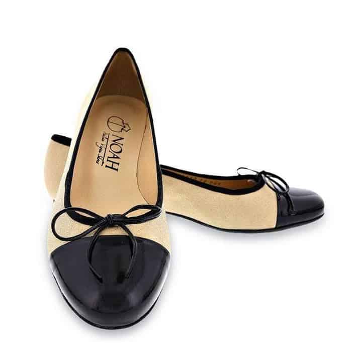 Beige flats with black vegan leather toe and black bow