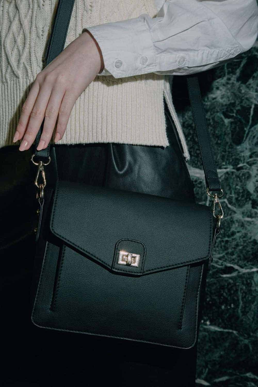 Person shown wearing black cactus leather crossbody bag