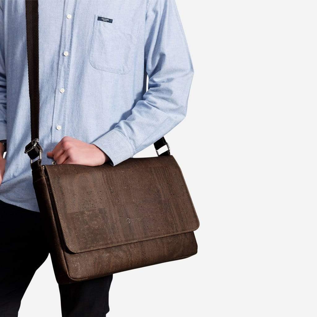 Person holding brown Corkor cork messenger bag