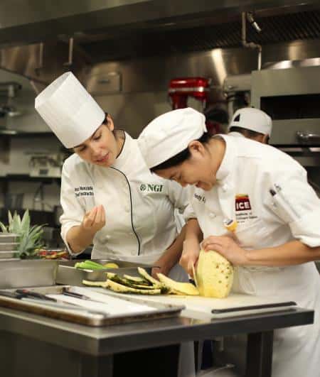 Chefs cutting pineapple at National Gourmet Institute, ICE