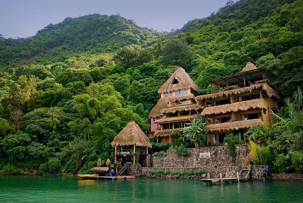 View of Laguna Lodge nestled among trees on the lake