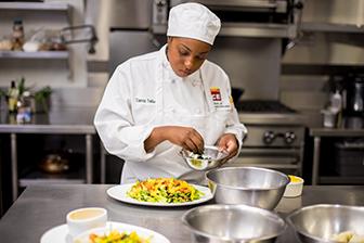 Chef preparing food at National Gourmet Institute, ICE