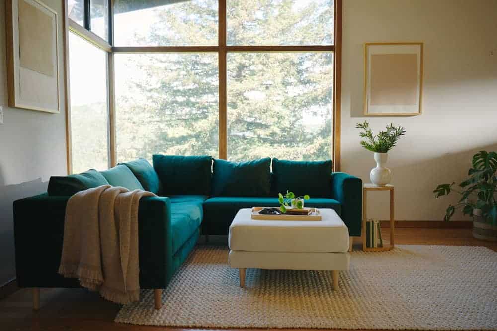 Green velvet Sabai corner sectional sofa in a room