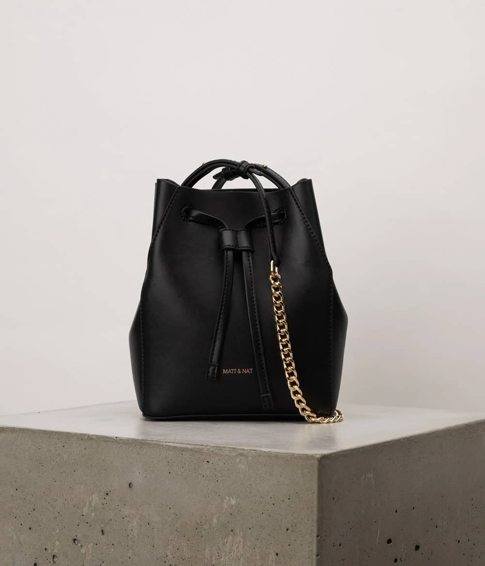 Black vegan leather bucket bag with gold chain strap from Matt and Nat