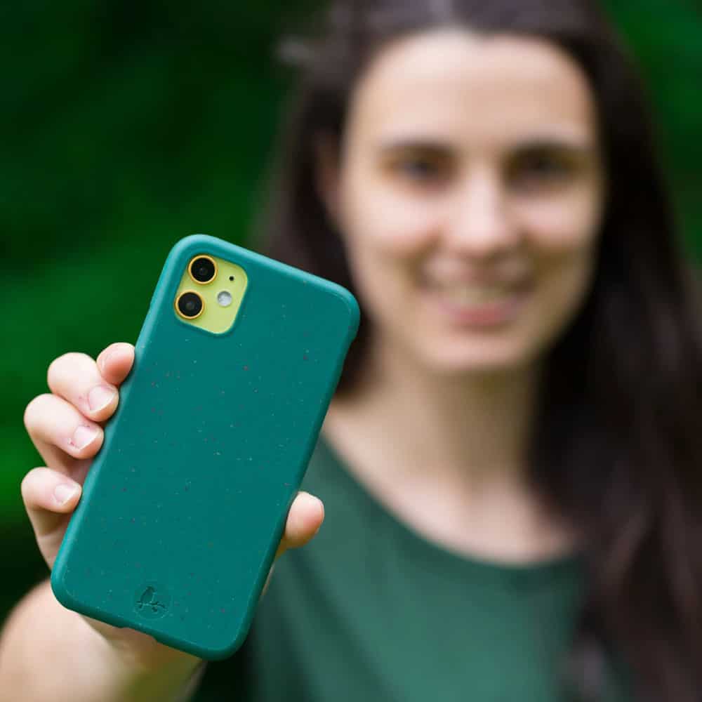 Person holding up dark green phone case