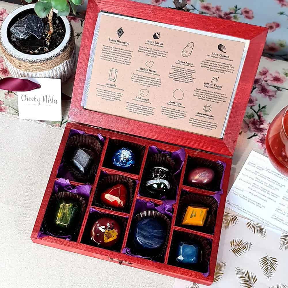 Box of vegan chocolates painted to look like precious stones