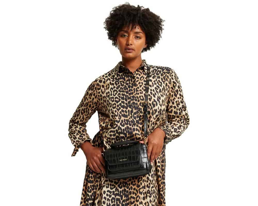 Person wearing Black vegan croc leather satchel from Sans Beast