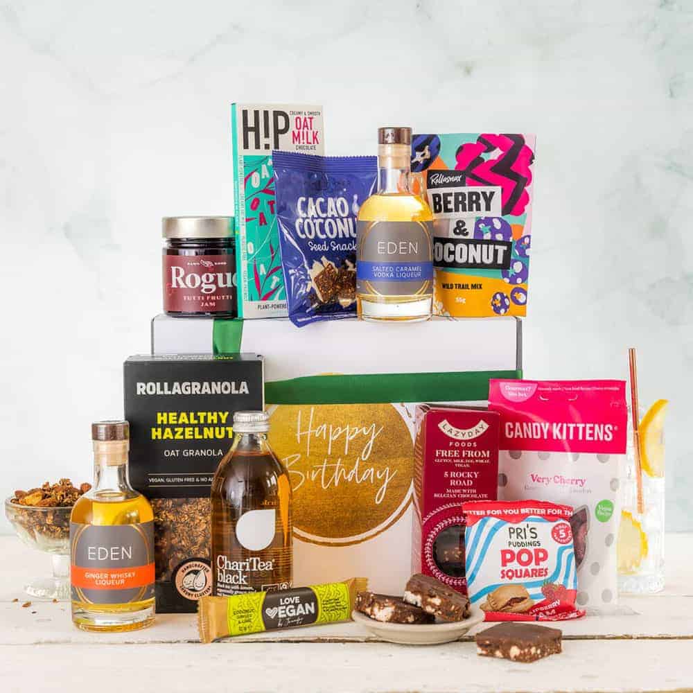Vegan birthday hamper which says "happy birthday", with snacks, liqueurs, tea and more