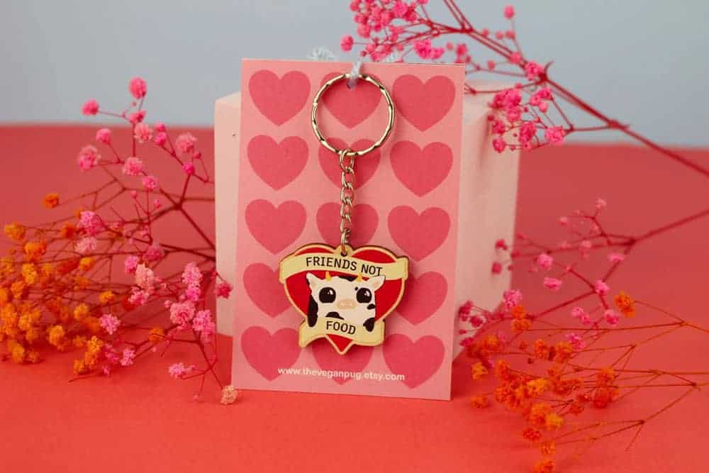 Keyring of cartoon cow that says "friends not food"