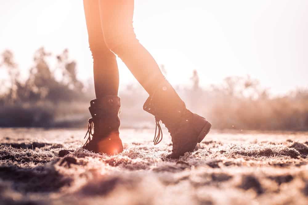 Person walking in combat boots (only legs visible)