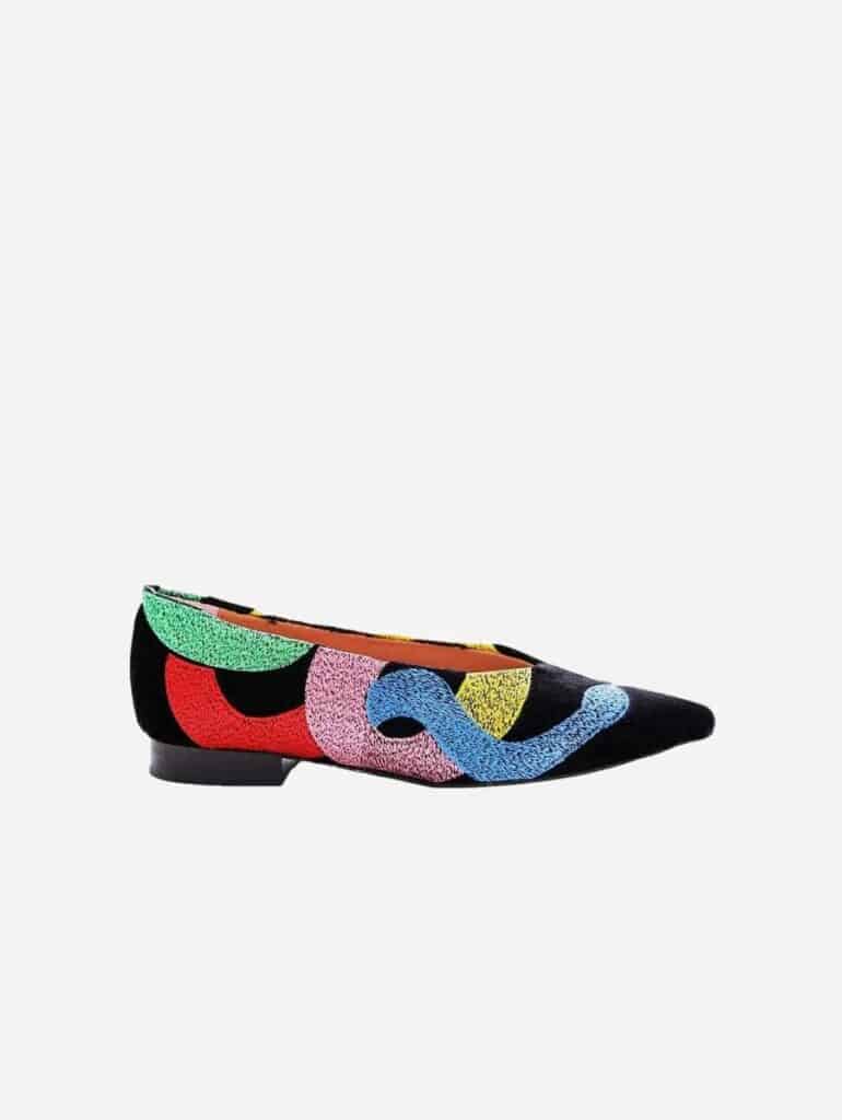 Embroidered black flats with embroidered strokes of colour in red, pink, blue, yellow and green