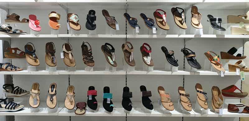 Rows of sandals on shelves in a shop