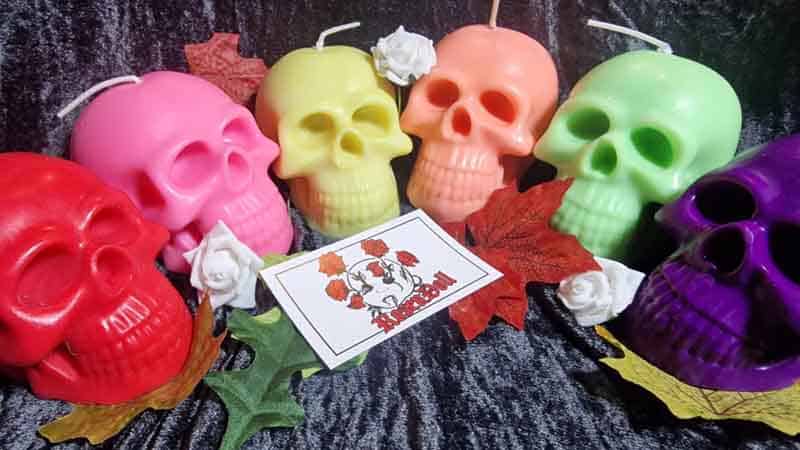 Row of neon skull candles in red, pink, yellow, orange and green