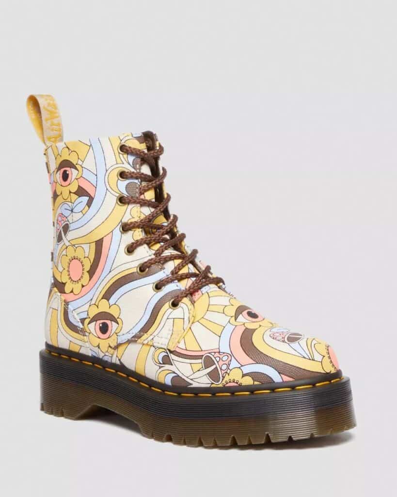 Vegan Dr Martens Jadon platform boots in canvas print with retro swirling pattern of brown, light orange and creamy yellow 70s style swirls, flowers and mushrooms in the print. with brown soles and brown laces.