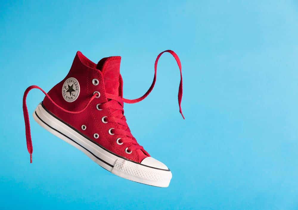 Red Converse high tops on a blue background
