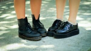 Two people wearing black Doc Martens boots