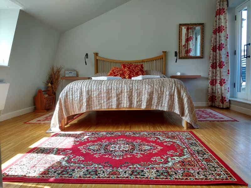 Room in Temple Lodge club: attic room with bed and rug