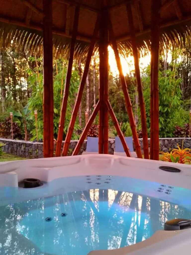 Hot tub with view of trees at  Volcano Eco Retreat, Heart Core Hotels, Hawaii