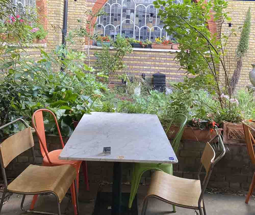 Seating in the garden area at Cafe Van Gogh, South London