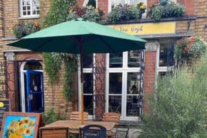Front garden/entrance and seating area to Cafe Van Gogh, a vegan cafe in South London